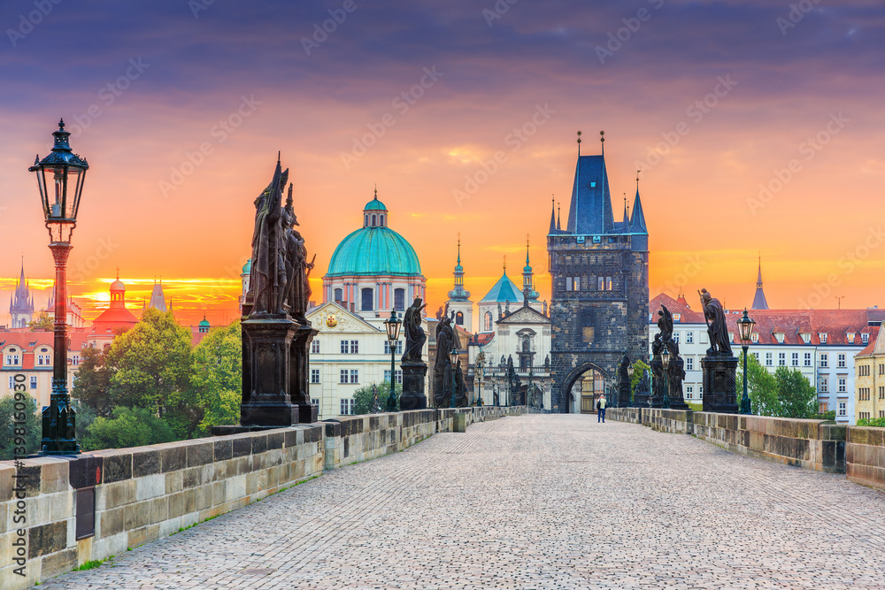 Prague, Czech Republic. Charles Bridge (Karluv Most) and Old Town Tower at sunrise.
