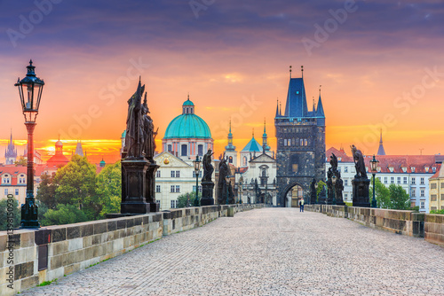 Prague, Czech Republic. Charles Bridge (Karluv Most) and Old Town Tower at sunrise.