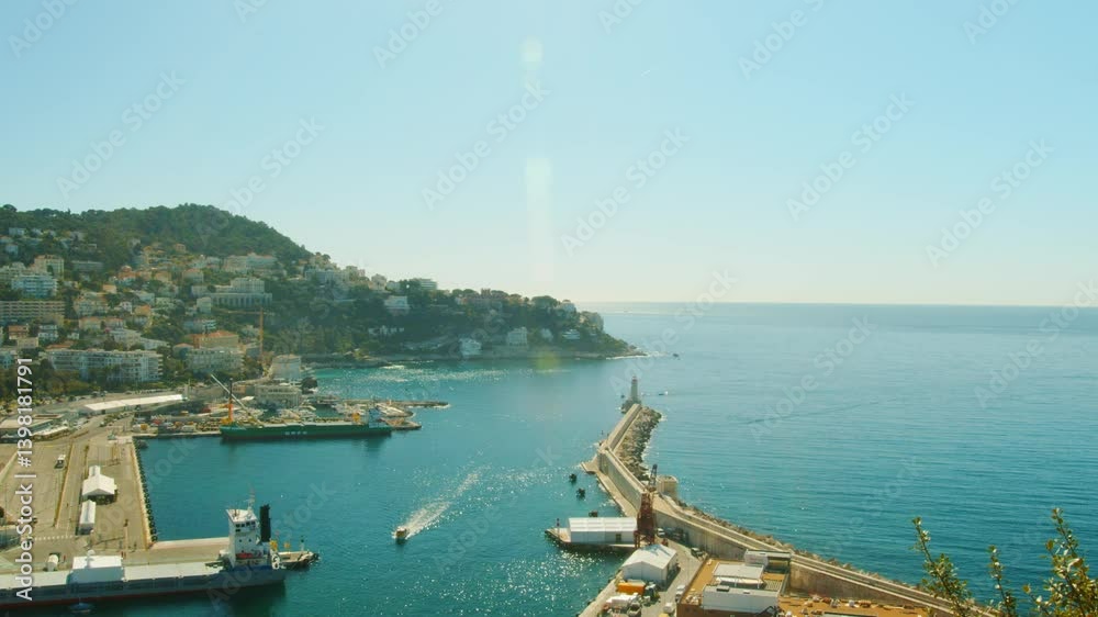 4K Nice French Riviera small boat sailing in the port with a beautiful view of the hills and the sea horizon in the background