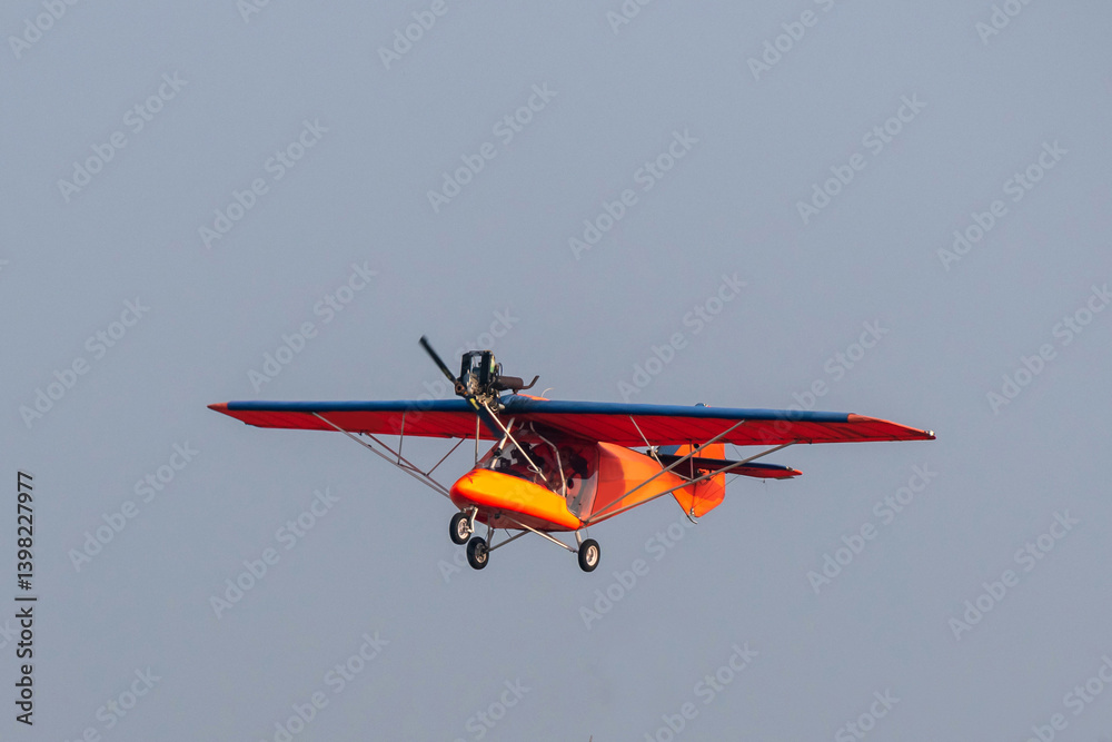 Propeller plane is flying on isolated blue sky Propeller plane is flying on isolated blue sky