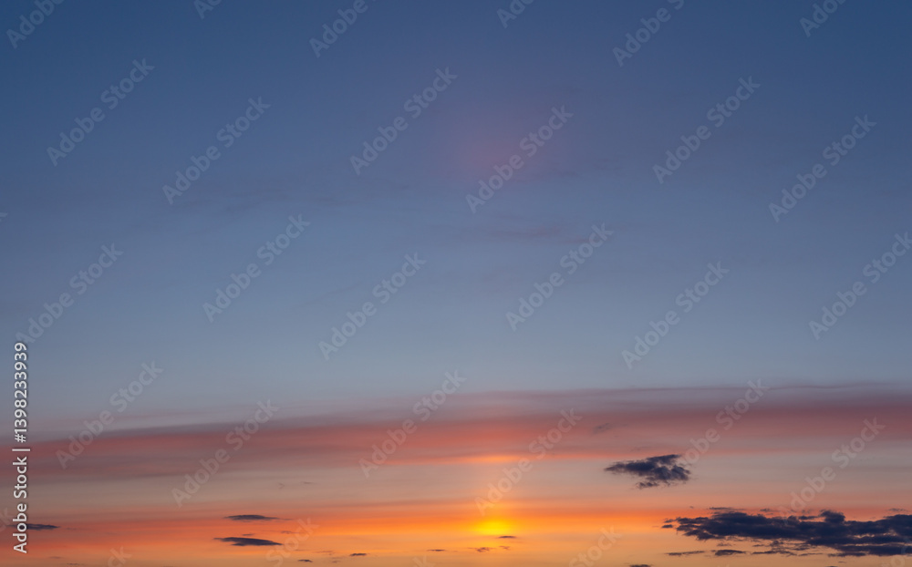 Obraz premium Orange sunset and golden sun in bright clouds