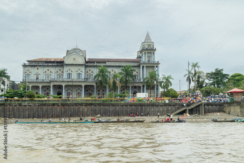 Naklejka premium Title Riverside view of Quibdó Malecon with Cathedral and riverboats 