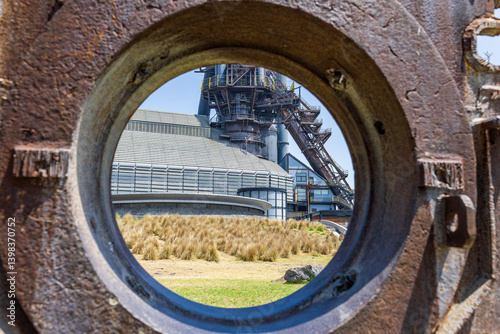 looking through metal sculpture at building