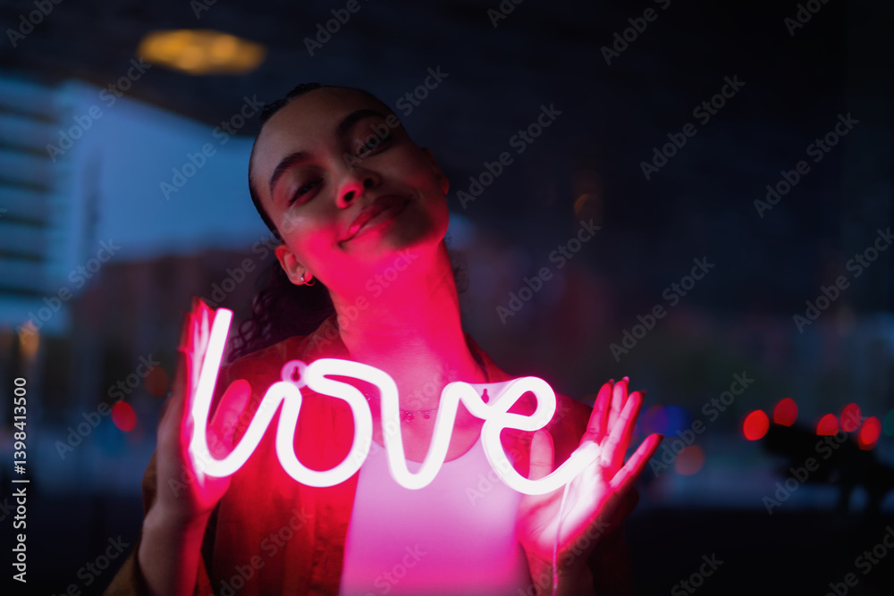 Thoughtful woman embracing neon