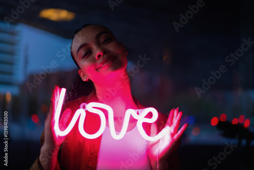 Obraz na płótnie Thoughtful woman embracing neon