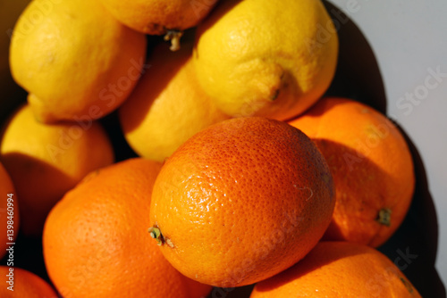 Oranges and lemons in a container.