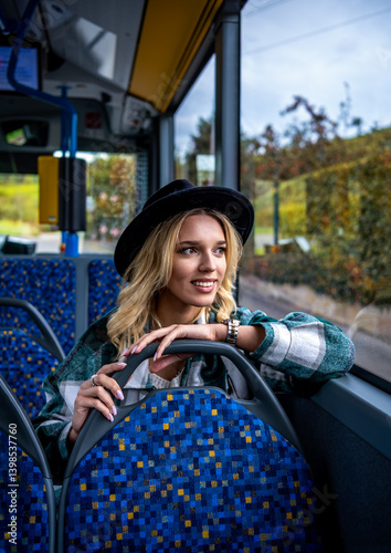 Smiling woman traveling by bus on an autumn day in Stuttgart, Germany