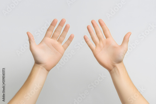Two open hands showing palms on gray background