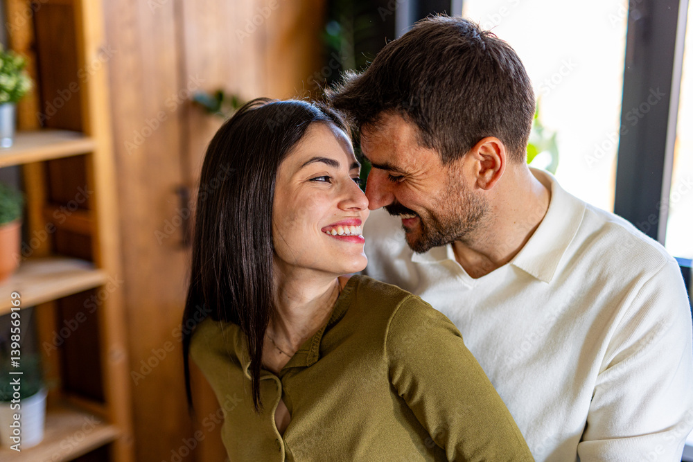 Romantic couple enjoying a tender moment together, smiling and sharing a loving look in their cozy home Romantic couple enjoying a tender moment together, smiling and sharing a loving look in their cozy home