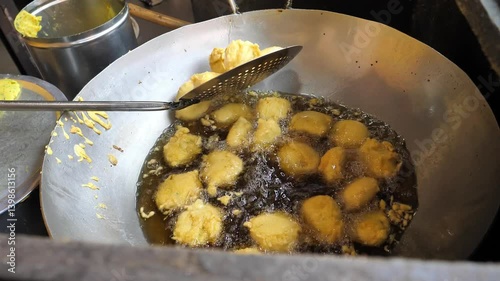 Vada used in the vada pav is taken out from hot oil after fry till it turns golden brown