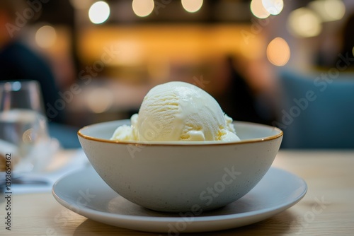 A scoop of creamy vanilla ice cream in a bowl. photo