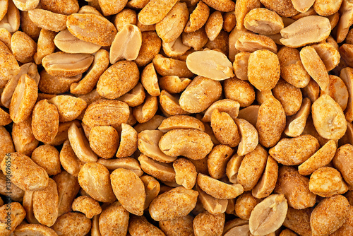 Fototapeta Naklejka Na Ścianę i Meble -  Roasted and spiced peanuts as background, top view. Peeled chili spicy peanuts.