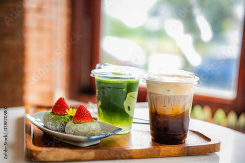 green tea moji daifuku sweets in plate with ice cofee and ice matcha green tea on table at cafe