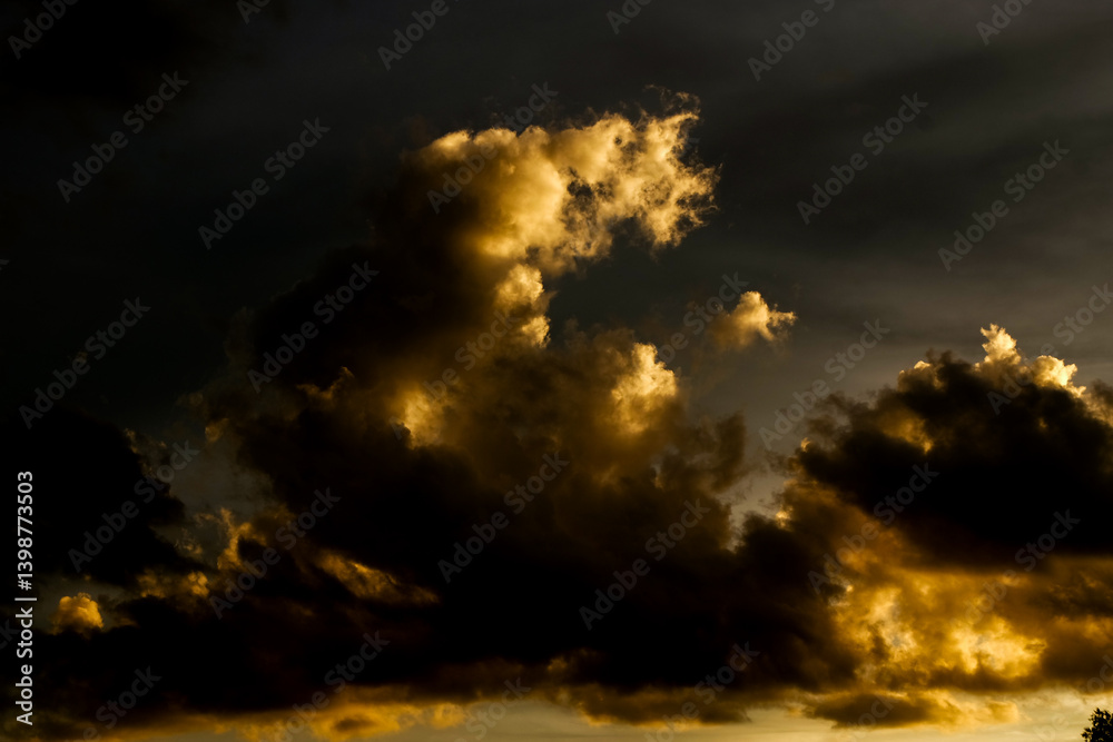 Dark Stormy Sky with Golden Clouds at Dusk in a Dramatic Scene Dark Stormy Sky with Golden Clouds at Dusk in a Dramatic Scene