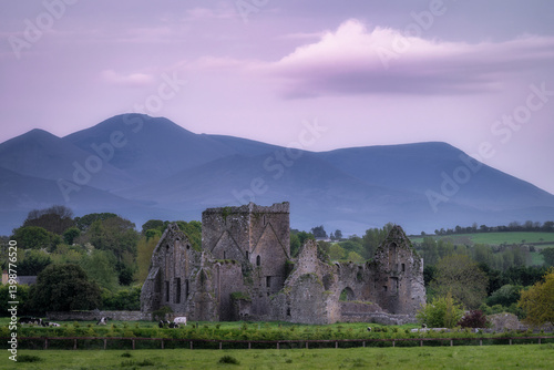 Obraz na płótnie Venture into the hauntingly beautiful sites of ancient ruins of Hore Abbey, beautifully nestled among the rolling hills and imposing mountains in the tranquil Irish countryside, Tipperary, Ireland w salonie