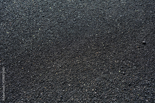 Obraz na płótnie Close-up image of black volcanic sand. The fine, gritty texture and dark tone make it ideal as a natural background or texture for design and creative projects. w salonie
