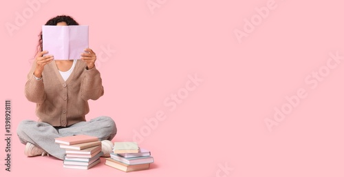 Young woman reading many bo...