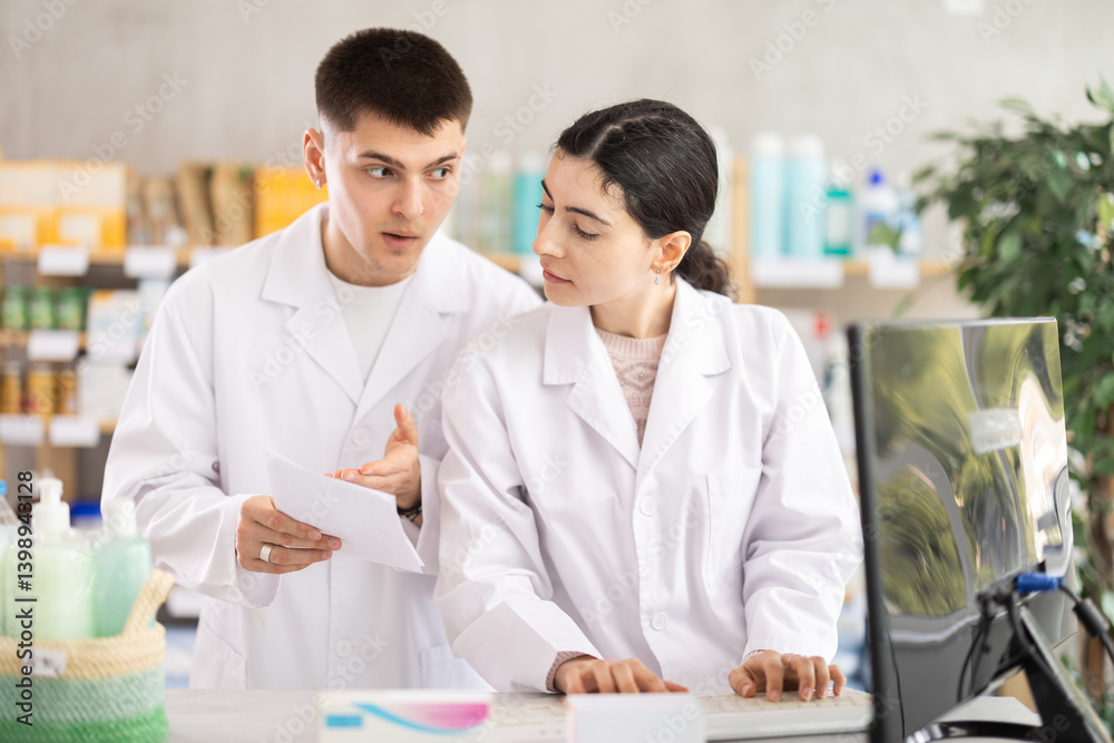 Two pharmacists employee using computer and prescription, remote document flow. Electronic database of drugs, international classification of diseases. Detailed list of drugs for treatment Two pharmacists employee using computer and prescription, remote document flow. Electronic database of drugs, international classification of diseases. Detailed list of drugs for treatment