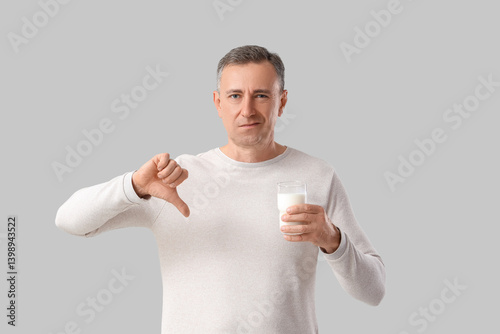 Mature man with glass of mi...