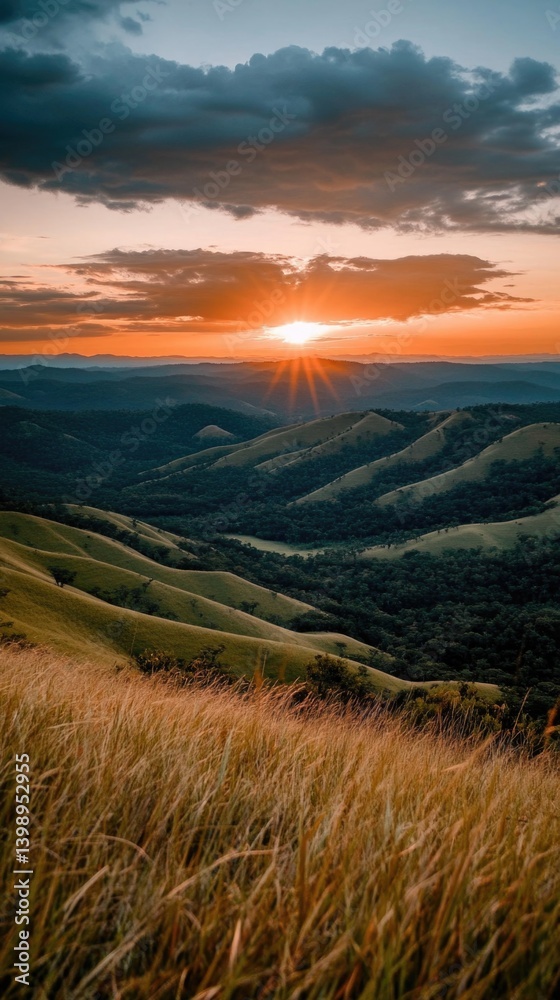 Fototapeta premium Stunning sunset over rolling hills and valleys with dramatic sky and lush greenery