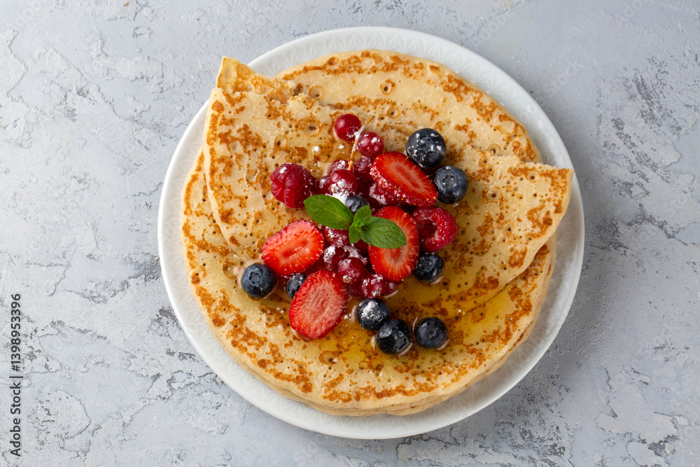 Healthy summer breakfast, homemade classic crepe with fresh fruit and honey