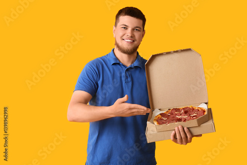 Young man pointing at cardb...