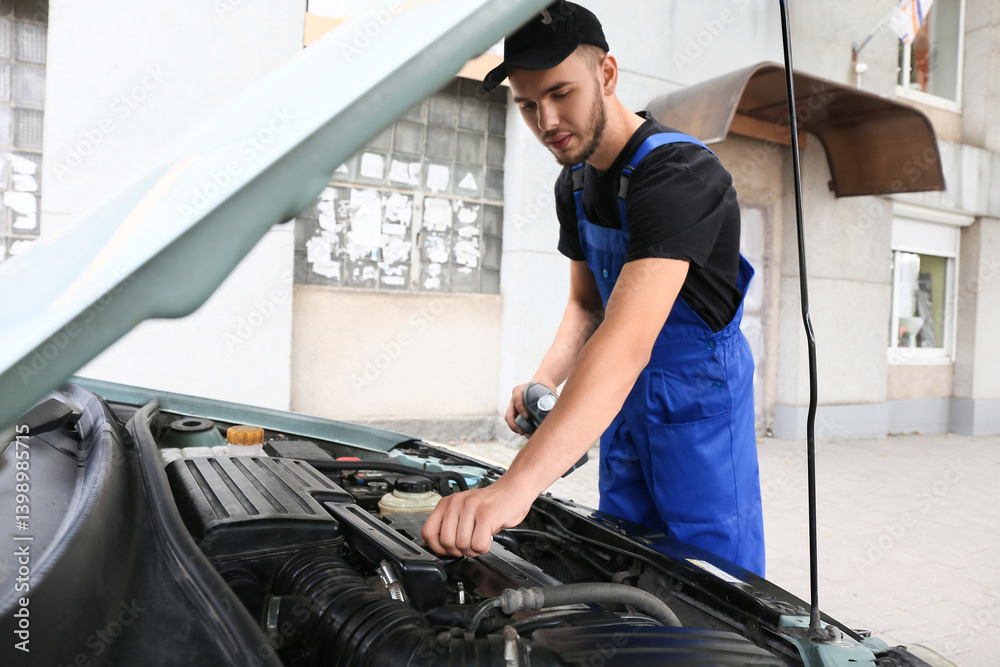 Ταπετσαρία Male mechanic refilling car oil outdoors