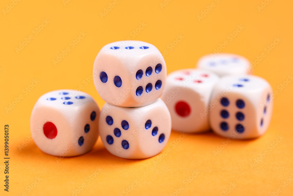 White game dices on orange background, closeup White game dices on orange background, closeup