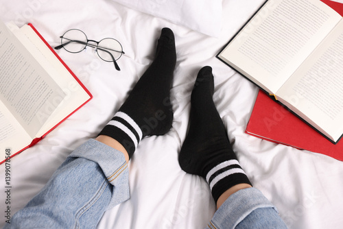 Obraz na płótnie Woman wearing black socks on bed, above view w salonie