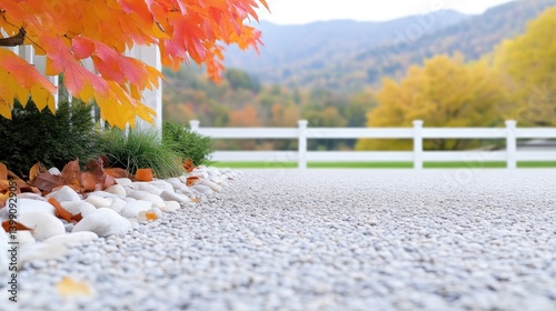 Obraz na płótnie Autumnal driveway with landscaping. Fall colors, white fence, and gravel path w salonie