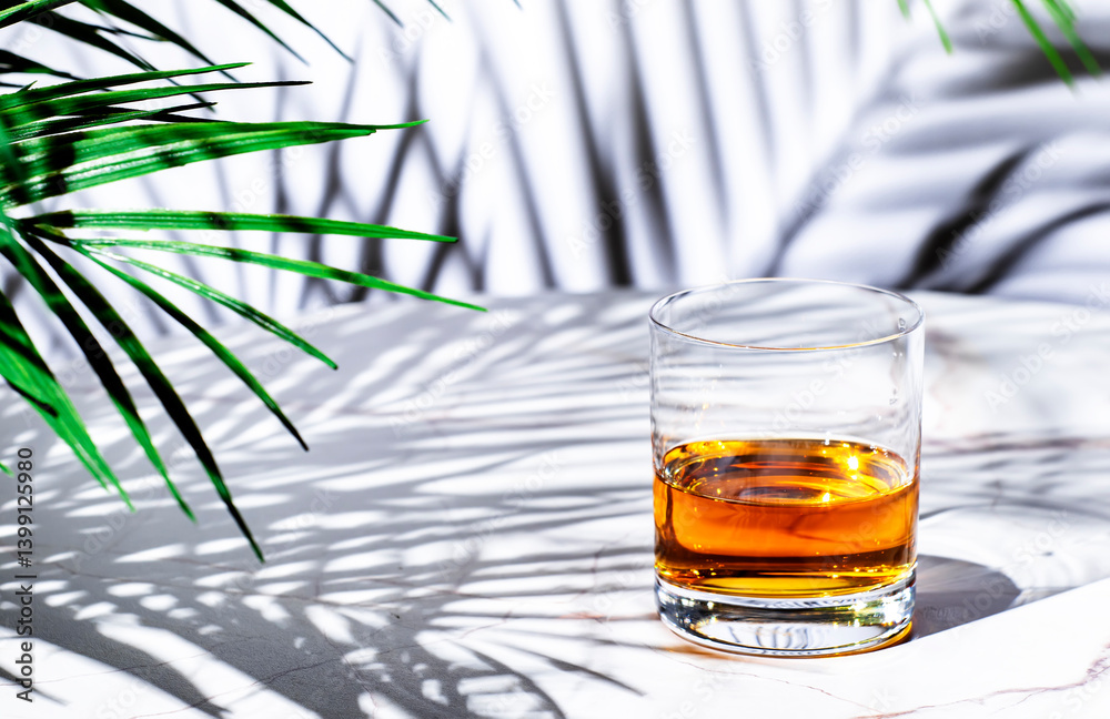 American single grain bourbon whiskey in glass on white background, hard light, leaves shadows