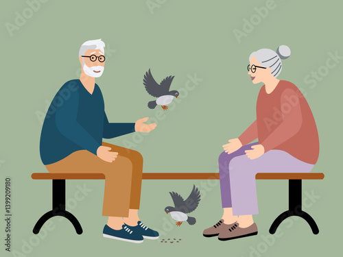 Senior man and woman feeding birds in the park  