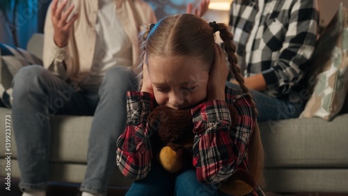 Obraz na plátně Sad child girl kid daughter upset suffering hugging toy Teddy bear close ears wi