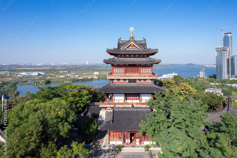 Aerial View of Traditional Temple Surrounded by Lush Greenery and Modern Cityscape