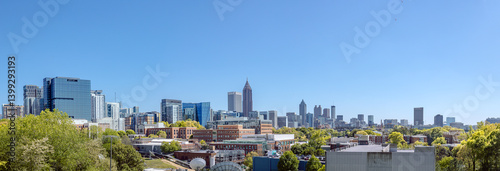 Obraz na płótnie Downtown, Midtown Atlanta Skyline showing several prominent buildings, highways, cars and hotels under a blue sky. w salonie