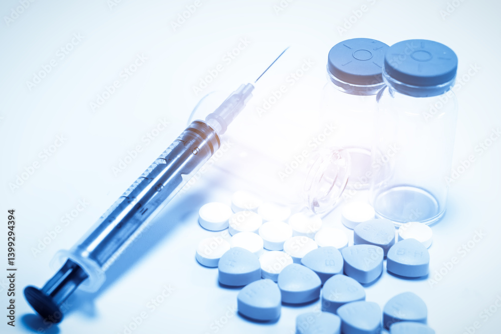 Modern Medicine Essentials: Syringe, Pills, and Vials on Soft Blue Background