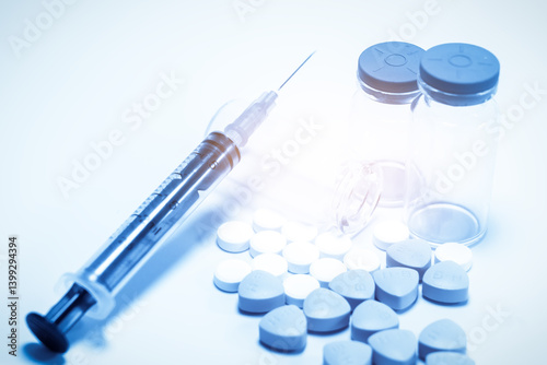 Obraz na płótnie Modern Medicine Essentials: Syringe, Pills, and Vials on Soft Blue Background w salonie