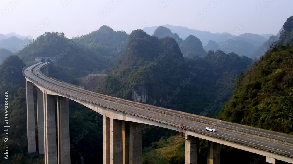 Aerial view of elevated highway in Guangxi's mountainous landscape Aerial view of elevated highway in Guangxi's mountainous landscape