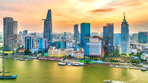 Beautiful sunset at skyscrapers along river light smooth down urban development in Ho Chi Minh City, Vietnam