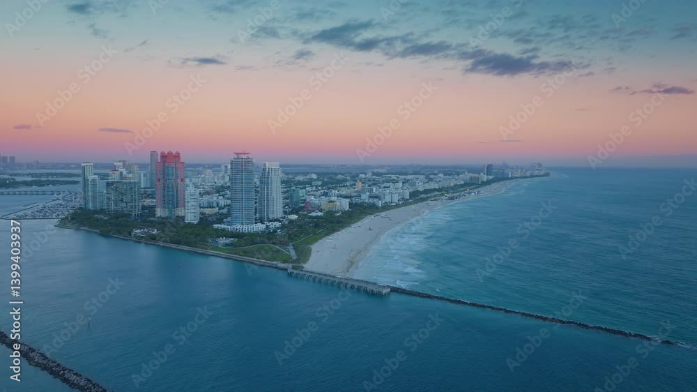 Experience a stunning sunrise at South Pointe Pier in Miami Beach, with captivating views of Fisher Island and Downtown Miamis skyline, showcasing Floridas breathtaking coastline and landscapes Experience a stunning sunrise at South Pointe Pier in Miami Beach, with captivating views of Fisher Island and Downtown Miamis skyline, showcasing Floridas breathtaking coastline and landscapes