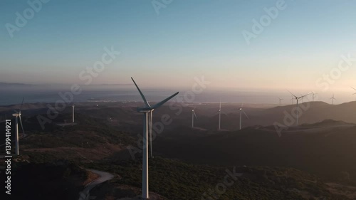 Drone aerial view of wind turbines create electricity close-up. Clean eco renewable green energy concept. Sustainable development. Windmill blades rotate produce power. Alternative eco-friendly farm.