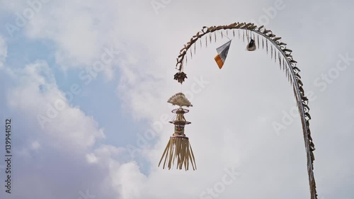 Bali, Indonesia, Penjor, a decorated bamboo pole with janur kuning, symbolizes gratitude and devotion in Balinese Hindu ceremonies, especially during Galungan.