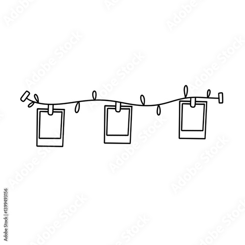 A string of lights with three picture frames hanging from it