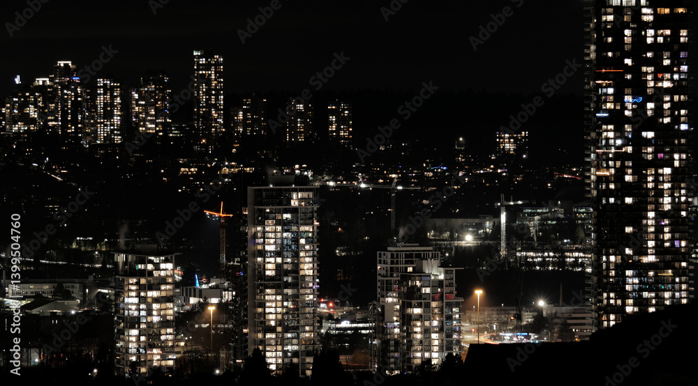 Obraz premium Skyline of Brentwood by night as seen from Capitol Hill during a December in Burnaby, British Columbia, Canada