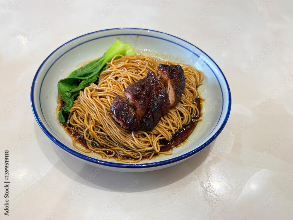chinese cook hong kong dry wanton roasted bbq char siew meat yellow egg noodle mee in dark soy sauce in plate on white marble table asian restaurant halal food cafe menu