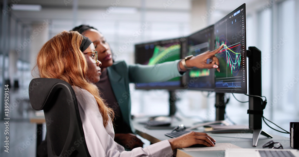 Analyzing stock market data, businesswoman views multiple screens