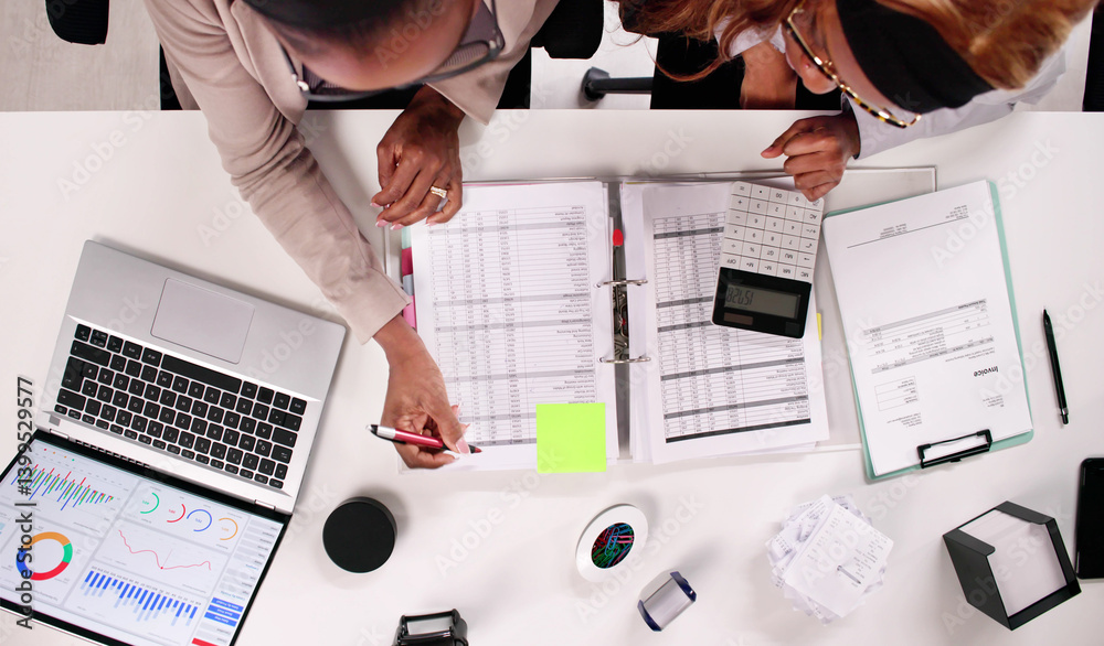 Skilled African American accountant deeply engrossed