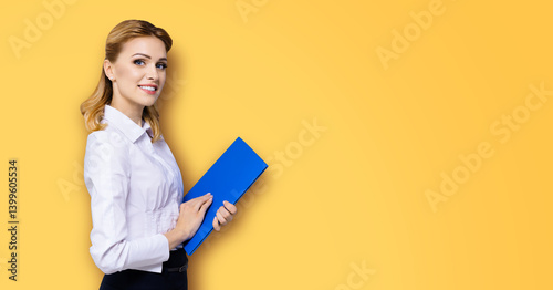 Portrait image - happy smile business woman businesswoman teacher, real estate agent hold blue folder. Blond hair girl in white shirt. Isolate orange yellow background. Ad concept. Free text space