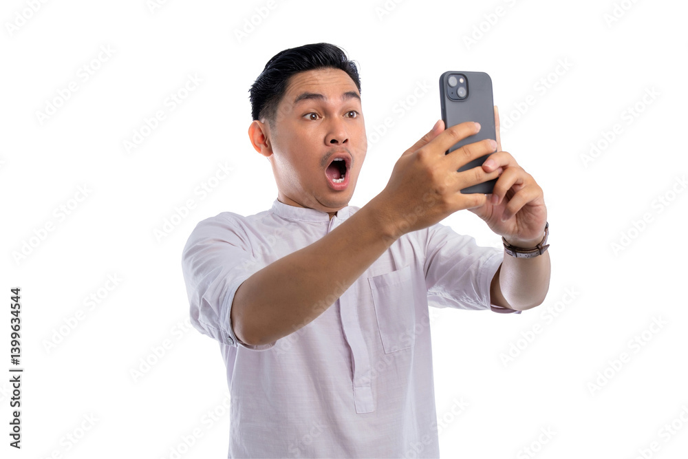 Surprised Asian Muslim man looking at mobile phone screen reacting to online news isolated on transparent background Surprised Asian Muslim man looking at mobile phone screen reacting to online news isolated on transparent background