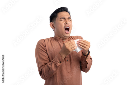 Unhealthy Asian Muslim man suffering flu-sick, sneezing loudly in tissue isolated on transparent background
